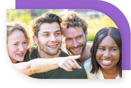 A group of young adults smile and share a moment as one of them points at something off camera.