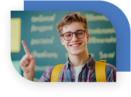A teen smiles and holds one hand up with his index finger pointing up. He is wearing a backpack and has a chalkboard behind him.