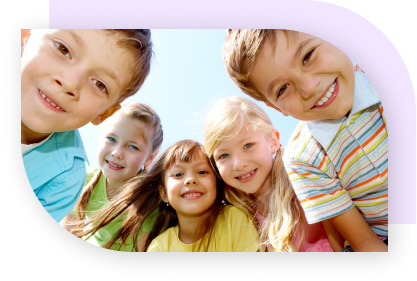 Five kids in a semi-circle looking down at the camera and smiling.
